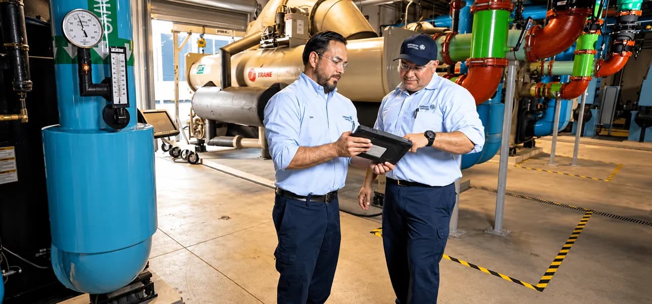 Field technicians reviewing equipment readings on a tablet