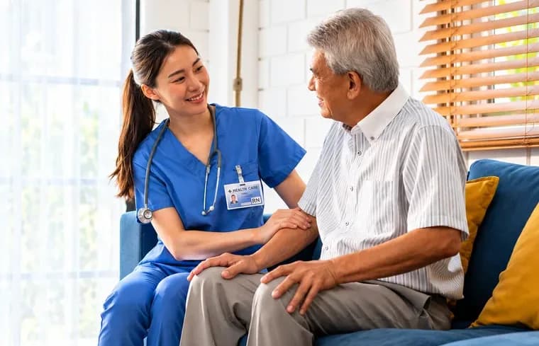 Caregiver supporting an older adult at home