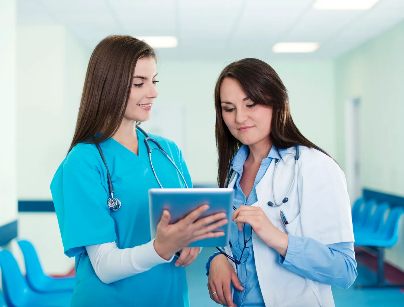 A healthcare professional in scrubs completing onboarding tasks on a phone