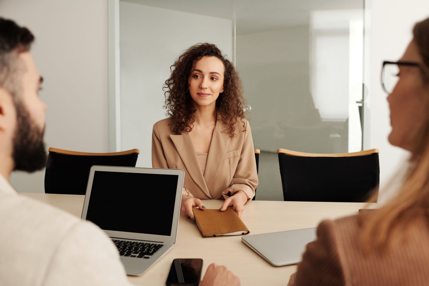 A candidate meeting with an HR team in a modern office