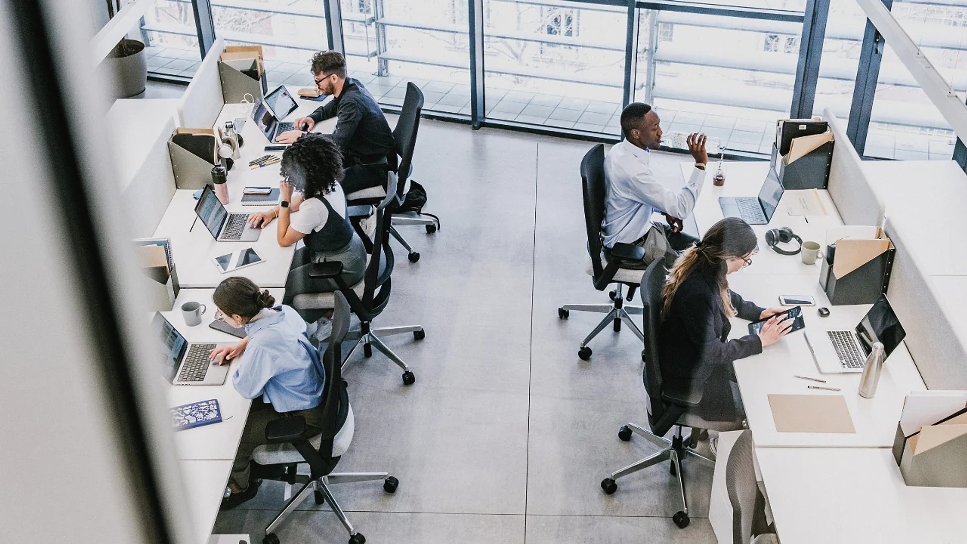 An overhead view of colleagues working at desks in an open-plan office