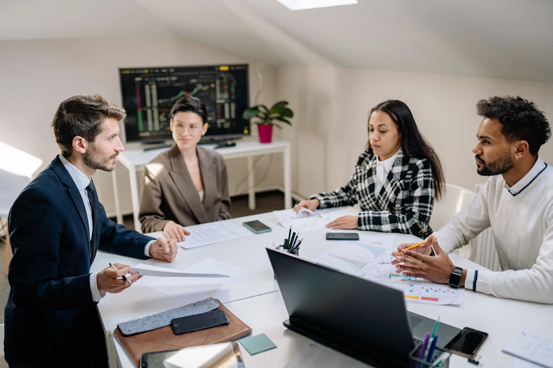 HR and operations leaders reviewing an onboarding plan in an office meeting